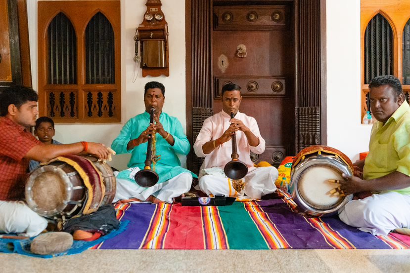 Nagaswaram players with thavil drummers performing at a Tamil Nadu doorway